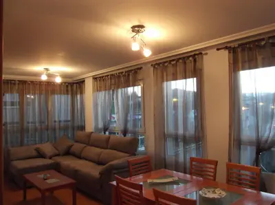 a living room with a couch and a table at Solaina Parking gratuito in Viveiro