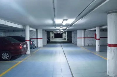 an empty parking garage with cars parked in it at H. O Lar in O Barco de Valdeorras