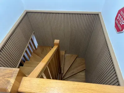 a wooden staircase with a stop sign next to it at Pilgrim’s House in O Pedrouzo