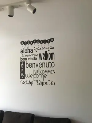 a wall with a sign on a white wall at Pilgrim’s House in O Pedrouzo