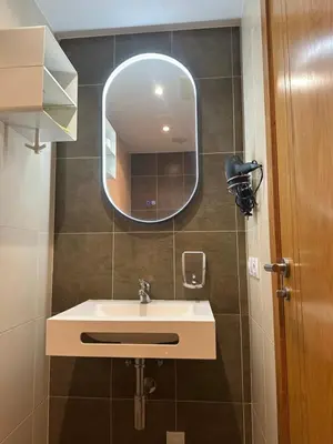 a bathroom with a sink and a mirror at Pilgrim’s House in O Pedrouzo