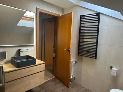 a bathroom with a sink and a mirror at Pilgrim’s House in O Pedrouzo
