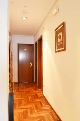 a hallway with a wooden floor and a door at Hotel Os Caracoles in Pereiro de Aguiar