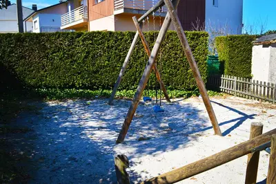 a swing set in a yard with a fence at Hotel Os Caracoles in Pereiro de Aguiar
