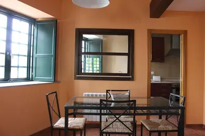 a dining room with a glass table and chairs at Casa Pedrosa in Mondoñedo