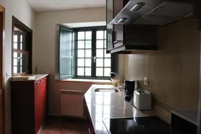 a kitchen with a counter and a sink and a window at Casa Pedrosa in Mondoñedo