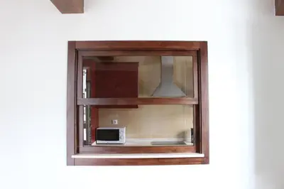 a window with a microwave sitting inside of it at Casa Pedrosa in Mondoñedo