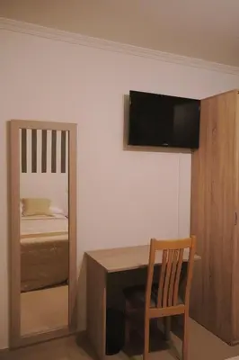 a room with a table and a bed and a television at Rosende in Arzúa