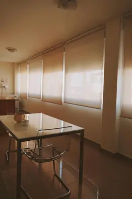 a glass table and a chair in a room at Rosende in Arzúa