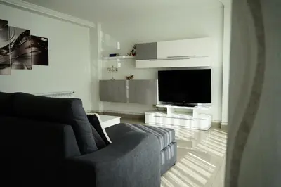 a living room with a couch and a flat screen tv at Rosende in Arzúa