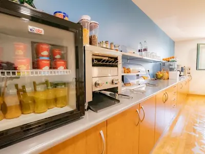 a kitchen with an open refrigerator filled with food at Pensión Palas in Palas de Rei