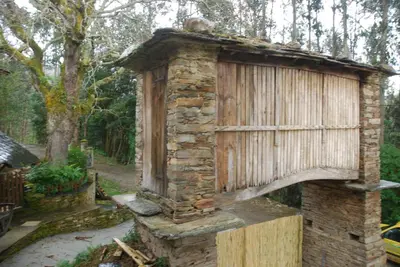 an old stone fireplace in a garden at Isabel Artemis ES in San Tirso de Abres