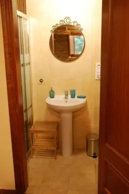 a bathroom with a sink and a mirror at Isabel Artemis ES in San Tirso de Abres