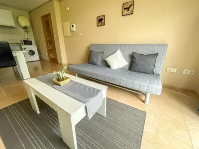 a living room with a couch and a table at Alojamientos Playa de las Catedrales 3000 in Barreiros