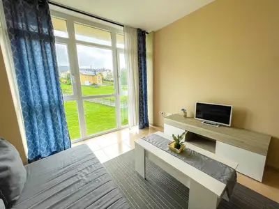 a living room with a tv and a large window at Alojamientos Playa de las Catedrales 3000 in Barreiros