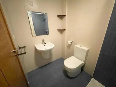 a bathroom with a toilet and a sink at Alojamientos Playa de las Catedrales 3000 in Barreiros