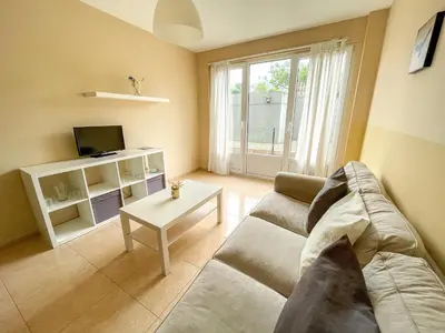 a living room with a couch and a table at Alojamientos Playa de las Catedrales 3000 in Barreiros