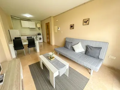 a living room with a couch and a table at Alojamientos Playa de las Catedrales 3000 in Barreiros