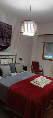 a bedroom with a bed with a red blanket at Cozy apartment in Orense of 45 m² with parking in Ourense