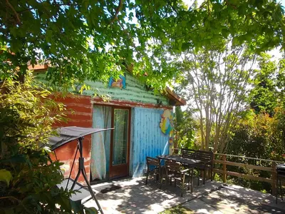 a house with a table and chairs in front of it at Apartamentos Rosa Jove in Cabañas