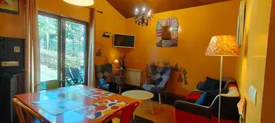 a living room with a table and a dining room at Apartamentos Rosa Jove in Cabañas