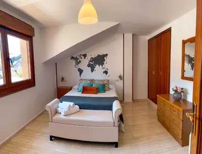 a bedroom with a bed with a map on the wall at Apartamento La Iglesia in Caldas de Reis