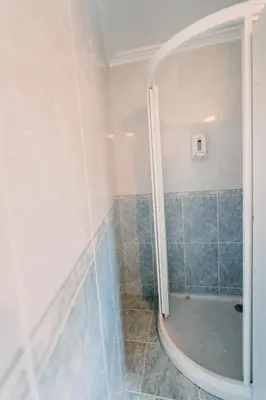 a bathroom with a shower with blue tiles at Apartamento La Iglesia in Caldas de Reis