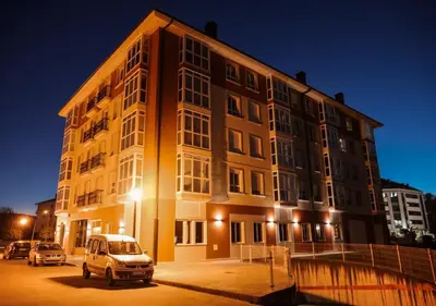 a van parked in front of a building at night at Pensión Rúa Peregrino in Sarria