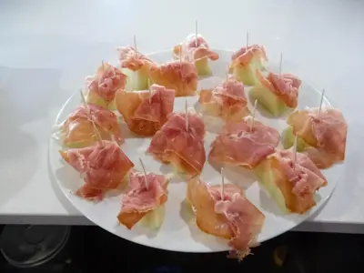 a plate of food with ham and apples on it at PENSIÓN RESTAURANTE 