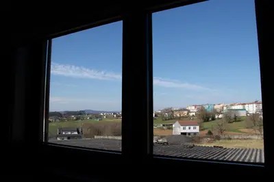 a window view of a city from a house at PENSIÓN RESTAURANTE 