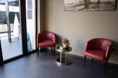 a waiting room with two red chairs and a table at PENSIÓN RESTAURANTE 