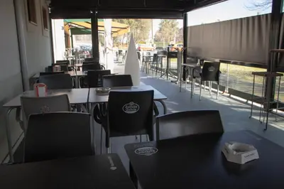 an empty restaurant with tables and chairs and a window at PENSIÓN RESTAURANTE 