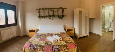 a bedroom with a bed with towels on it at Villa Galicia in Caldas de Reis