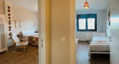 a room with a bedroom with a bed and a chair at Villa Galicia in Caldas de Reis