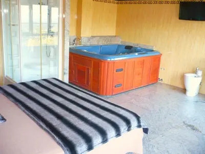 a bathroom with a large tub in a room at Pensión Bos in Bergondo