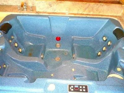 a blue bathtub with a red ball in the middle at Pensión Bos in Bergondo