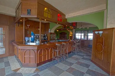 a large kitchen with a bar with stools at Pensión Bos in Bergondo