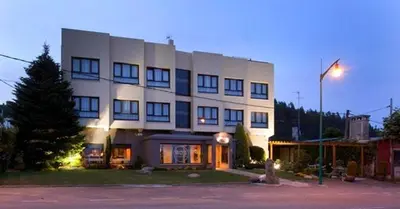 a large white building with a street light in front of it at Pensión Bos in Bergondo