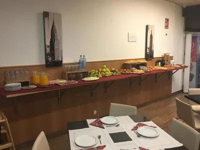 a buffet with plates of food on a table at Hotel Ril in Burela de Cabo