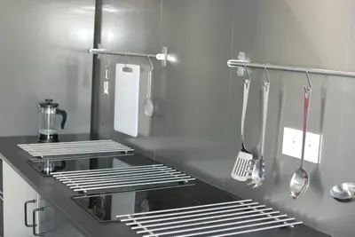 a kitchen with a sink and utensils at Albergue Xabarín in Abadín