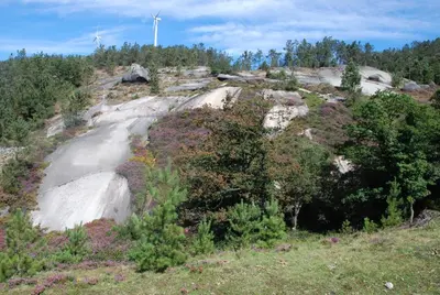 a hill with a wind turbine on top of it at Albergue Xabarín in Abadín