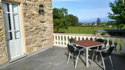 a wooden table and chairs on a patio at Casa Rubal in Foz