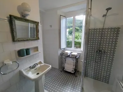 a white bathroom with a sink and a shower at Casa Rubal in Foz