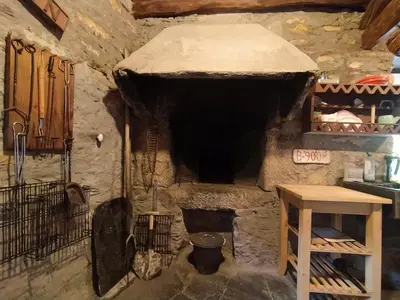 a stone oven in a kitchen with a wooden table at Casa Rubal in Foz