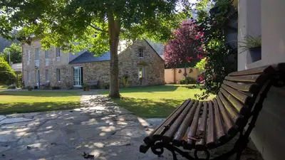 a park bench sitting in front of a building at Casa Rubal in Foz