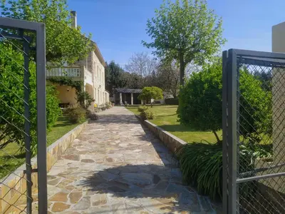 a gate to a garden with a stone walkway at Casa Rubal in Foz