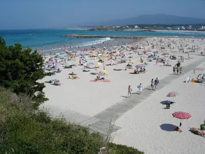 a large group of people on a beach at Casa Rubal in Foz