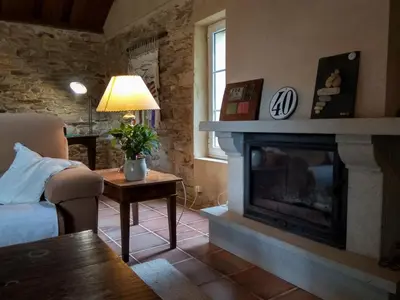 a living room with a fireplace and a couch at Casa Rubal in Foz