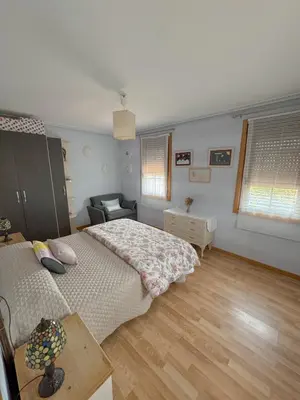a bedroom with a bed and a couch in it at Casa Idalia in Ourense