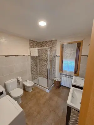 a bathroom with a shower and a toilet and a sink at Casa Idalia in Ourense